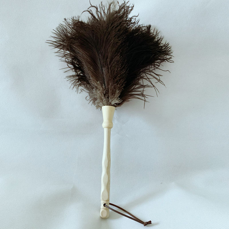 Black ostrich feather duster with beige woolden handle