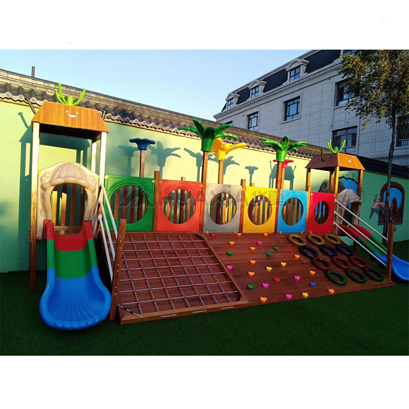 Wooden outdoor playground with climbing wall
